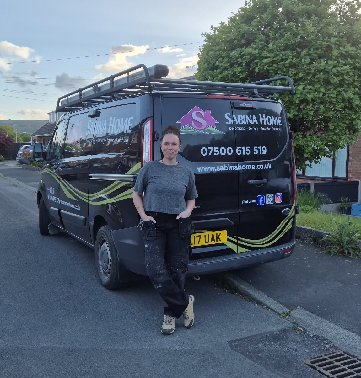 Sabina, leaning against her work van — Sabina Home / Miss Fix It